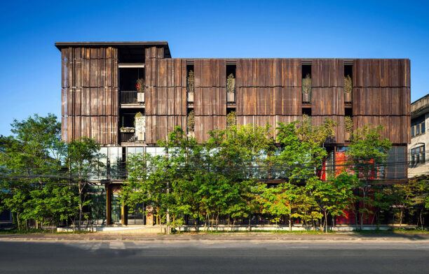 The perforated metal screens of the façade of Oui J'aime Hotel By Wallasia provide guests with privacy and sunshade during the day.