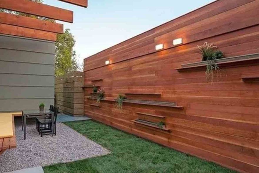 modern outdoor fence with floating shelves and built in lights