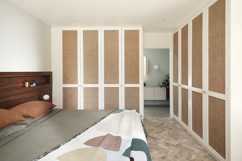 Bedroom with built in white and brown cupboards and terracotta floors inBathroom with green tiles and white grout in Wahroonga House by Tom Mark Henry.