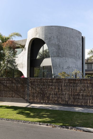 A cylindrical section of Brush House concrete facade with a large arched window cut from it.