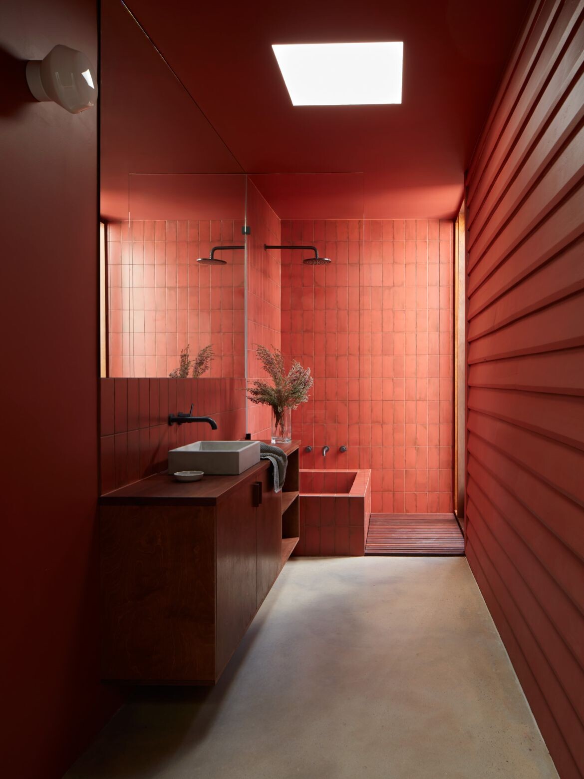 The main guest bathroom is lined with a rich ochre tile