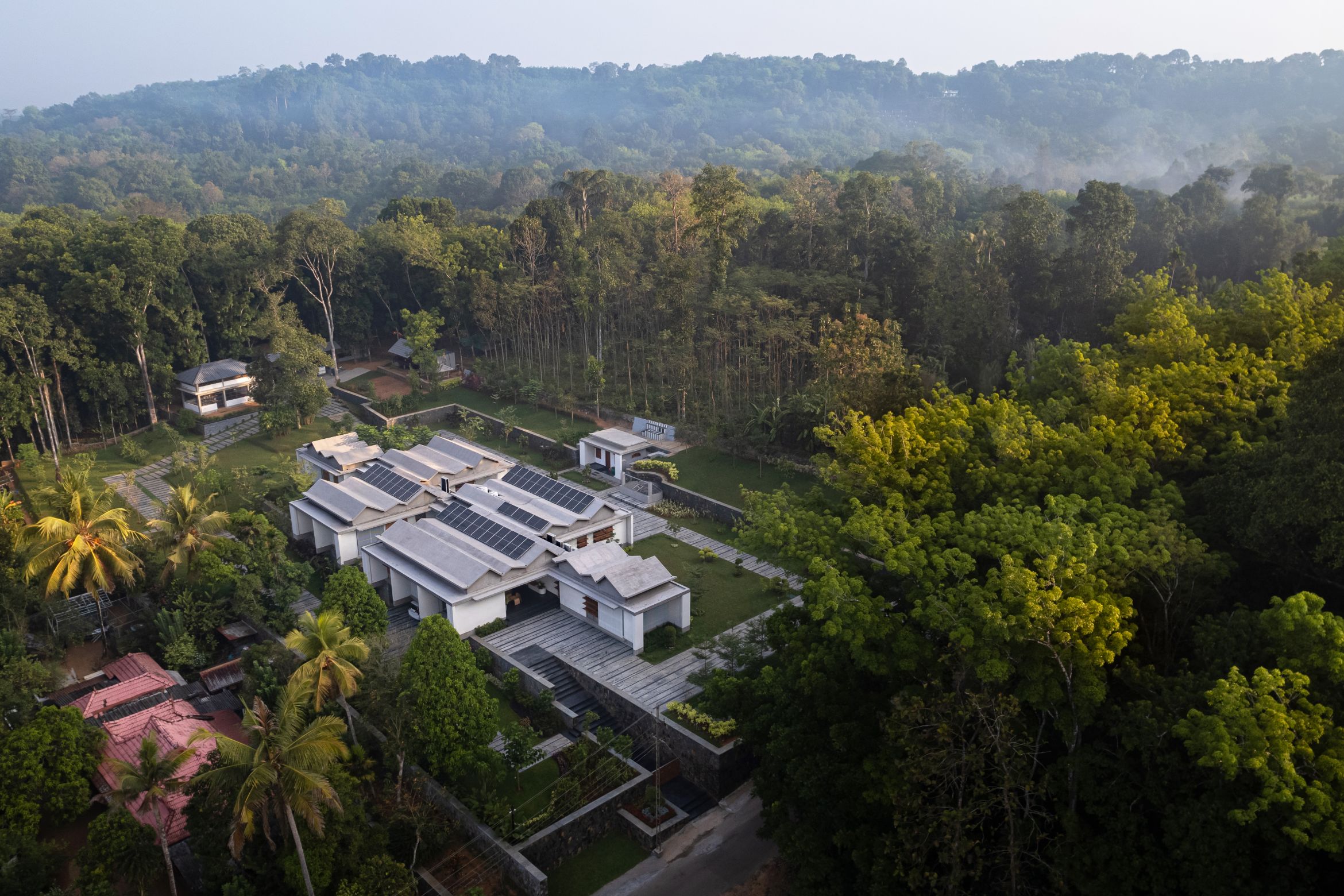 This home emerges from within a rubber plantation in Kerala