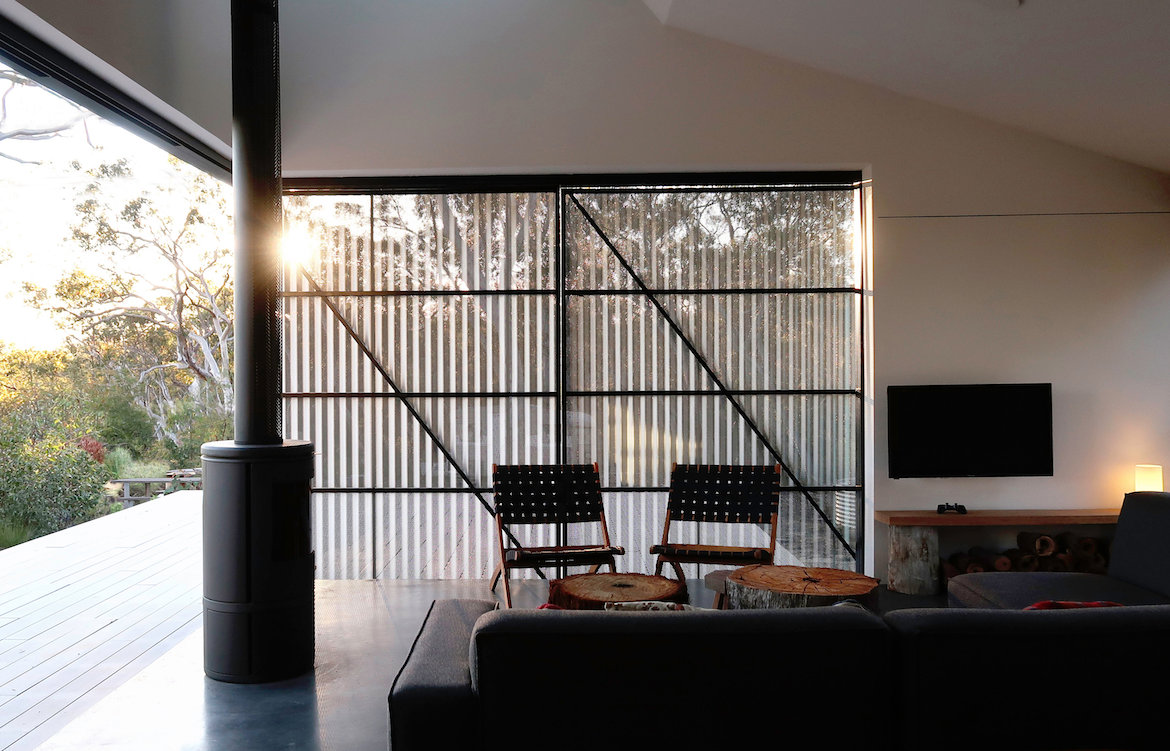 The living room of Off Grid House at sunset.