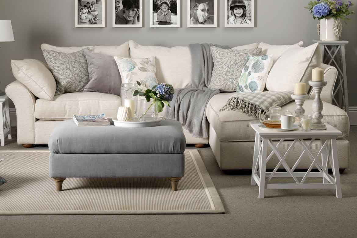 light grey carpet with white couch beige rug and art