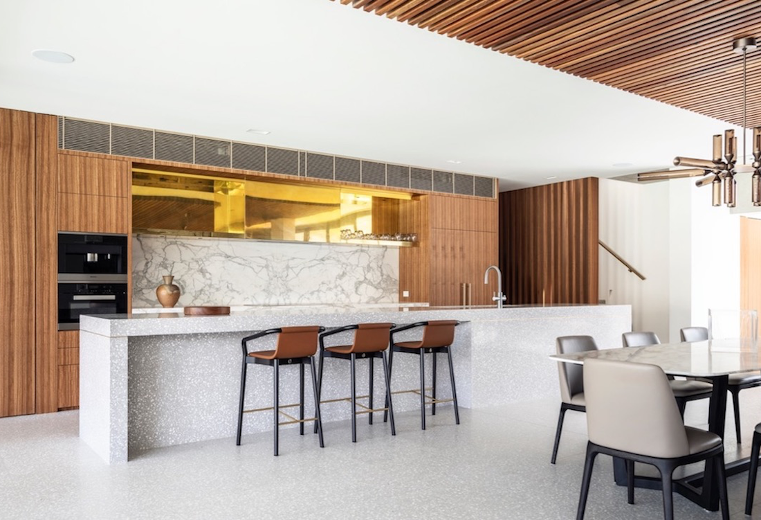 The kitchen's bespoke terrazzo island bench and sustainable timber veneer cabinetry.