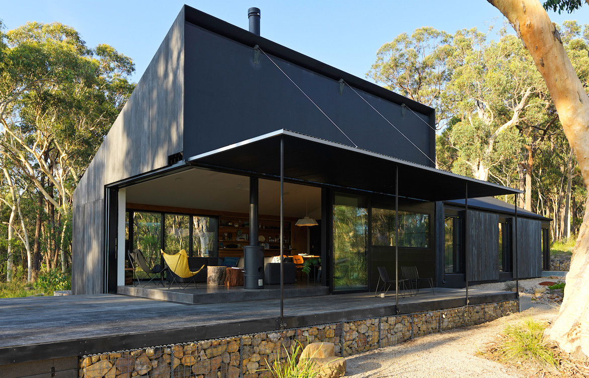 Exterior of Off Grid House when the fireproof shutters are open.