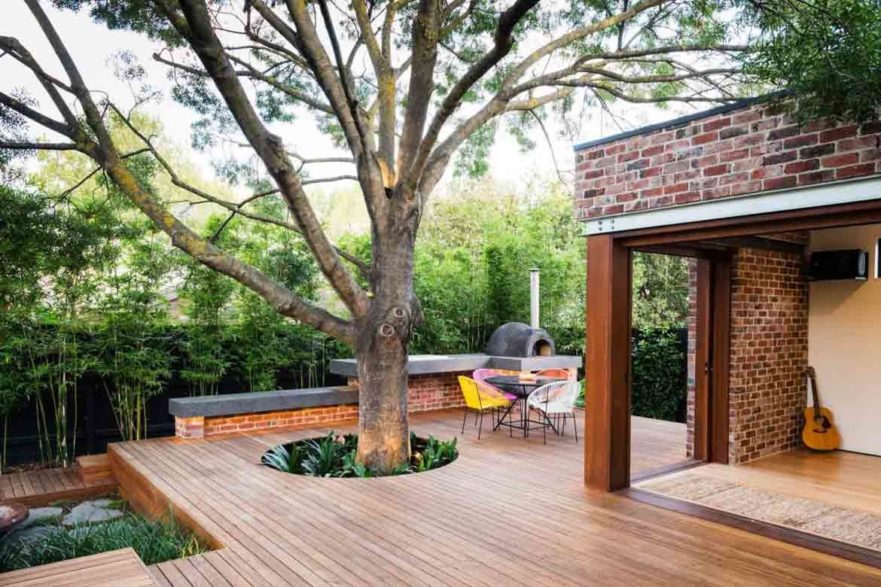 custom made deck with tree outside of house backyard