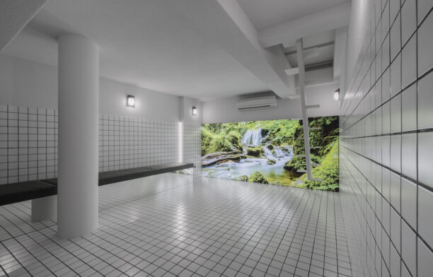 A large white tiled basement space with a display of a jungle waterfall on one side in 55 Sathorn.