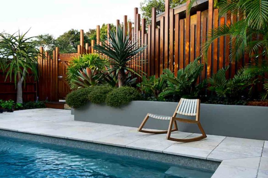 timber pool fence natural material stylish design artistic uneven layered timber fence