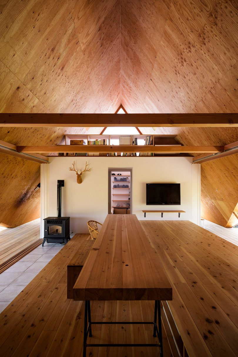 A view across the long dining table in Hara House, placed directly under the centre of the pitched roof.