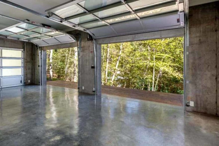shiny polished concrete floor in garage open door green trees outside