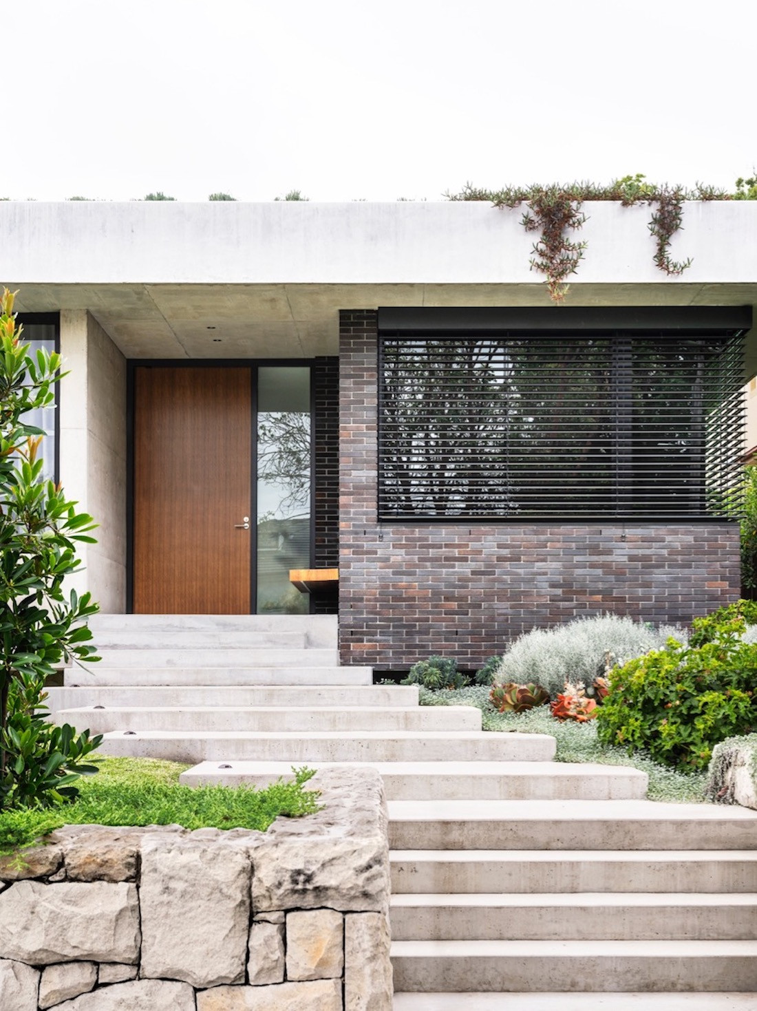 A stone pathway leads up to the home's wooden front door.