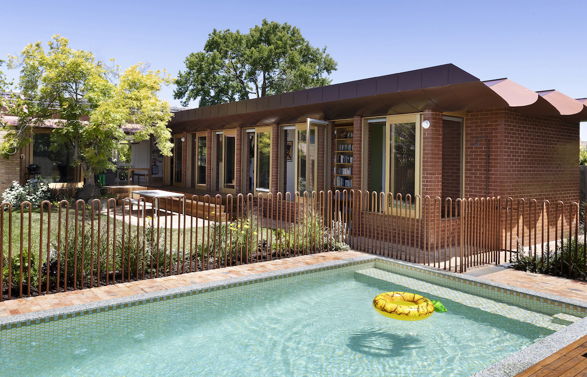 A pool in the foreground and the Wowowa glazed brick extension in the background.