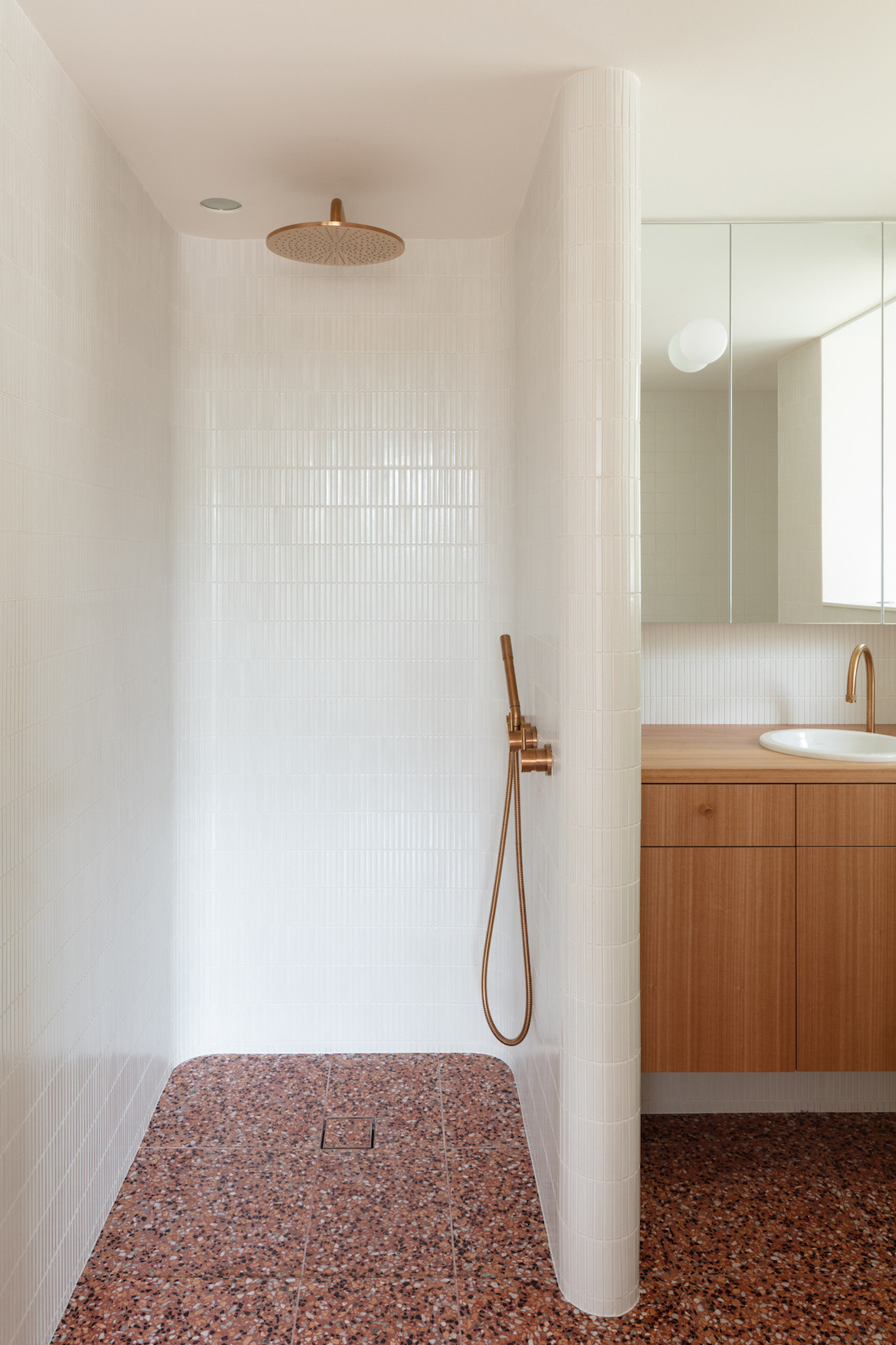 Curved bathroom wall with local red terazzo tiles.