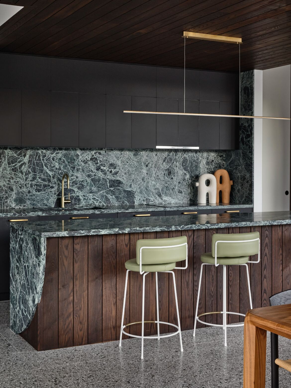 A statement kitchen with an incredible green stone features at Sorrento Beach House