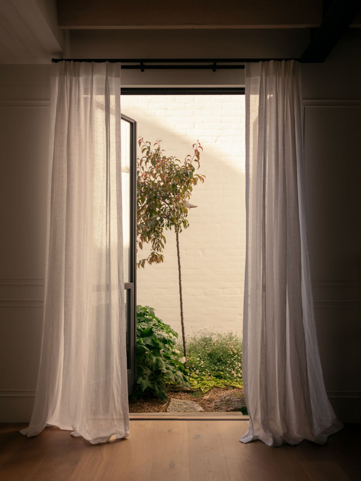 A white brick wall, Richards Stanisich found ways to bring in nature at Armidale Residence