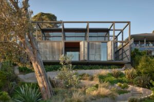 This absolute beachfront home sensitively frames the view