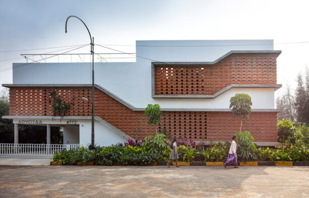 The brutalist exterior of Inside Out House by Gaurav Roy Choudhury Architects has a brutalist exterior with breeze blocks