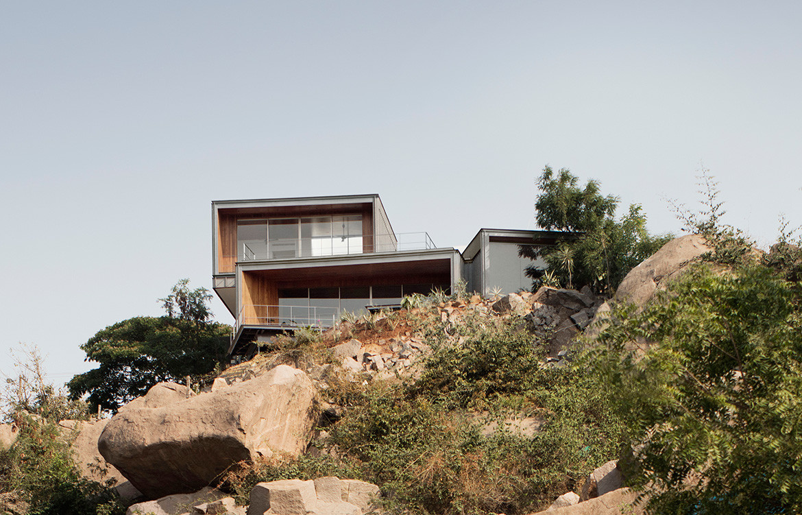 The Lakehouse by CollectiveProject hides atop the hills of Hyderabad, India, overlooking HiTec City and the Durgam Cheruvu Lake