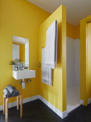 Colourful bright yellow quirky bathroom in Walkerville Pod House by NRN Architects