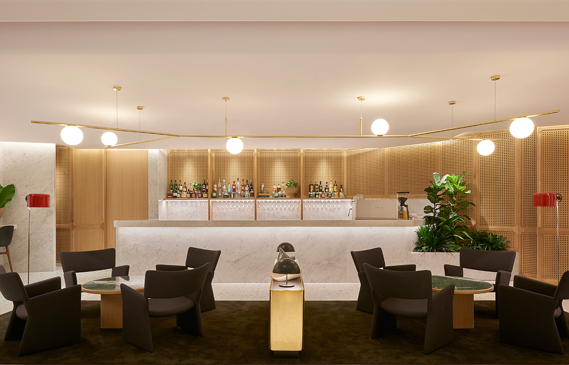 Carrara marble, European oak, brass finishes, and plush carpets make the luxurious interior design of the Qantas First Lounge Singapore by Caon Studio and Akin Atelier.
