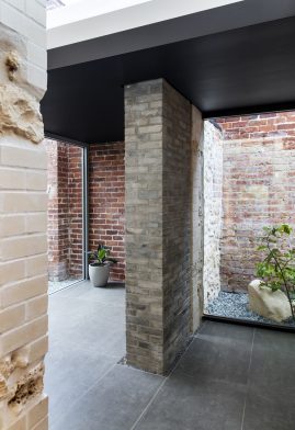 An intersection of historic limestone, 20th century red clay brick and modern grey brick in Orient Street House by Philip Stejskal