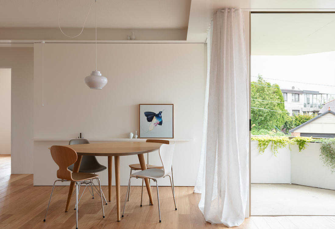 Sliding wall and small circular dining table, next to an open sliding door.